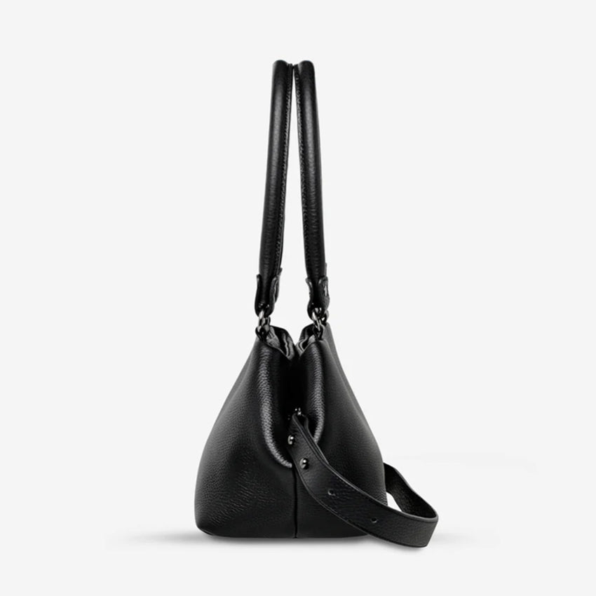 A side profile of the Status Anxiety Astral Bag in Black on a blank background