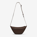 A back view of the Status Anxiety Glued To You Bag in Cocoa on a grey background