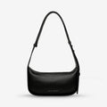 The Status Anxiety Haven Bag in Black on a grey background