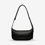 The Status Anxiety Haven Bag in Black on a grey background
