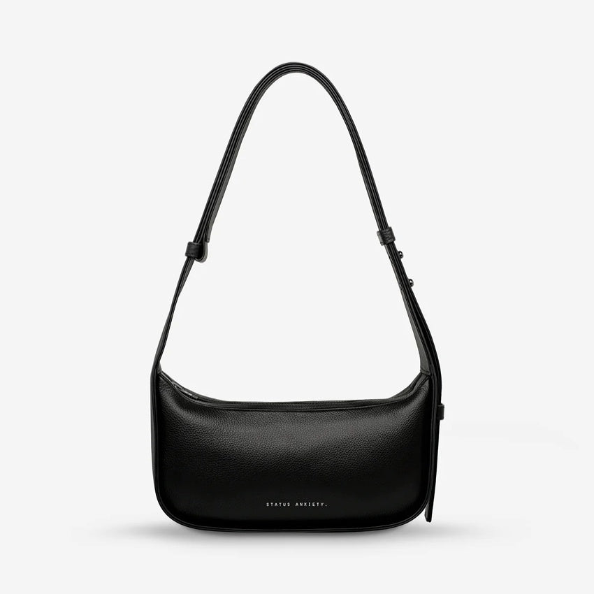 The Status Anxiety Haven Bag in Black on a grey background