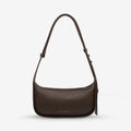 The Status Anxiety Haven Bag in Cocoa on a grey background