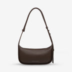 The Status Anxiety Haven Bag in Cocoa on a grey background