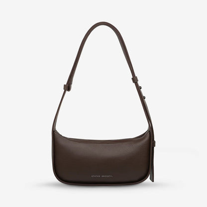 The Status Anxiety Haven Bag in Cocoa on a grey background