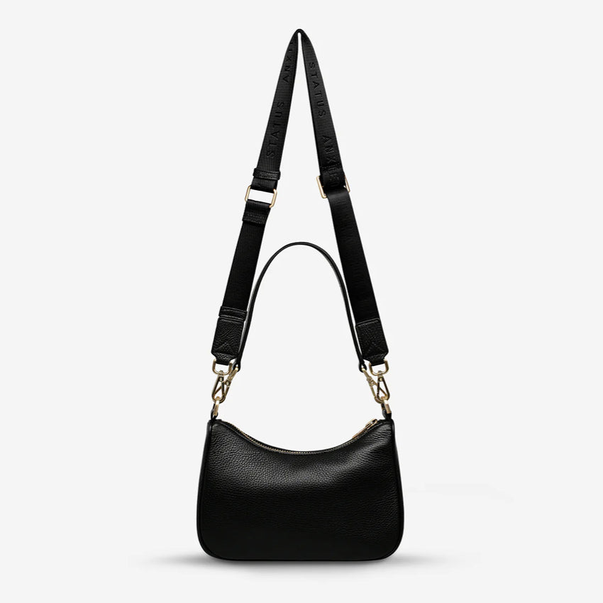 A back view of the Status Anxiety Look Both Ways in Black and Brush Gold on a blank background 