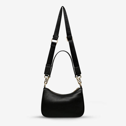 A back view of the Status Anxiety Look Both Ways in Black and Brush Gold on a blank background 