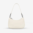 The Status Anxiety Look Both Ways Bag in Chalk with just the short strap on a grey background