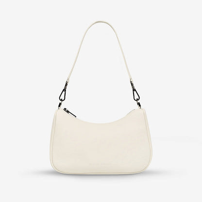 The Status Anxiety Look Both Ways Bag in Chalk with just the short strap on a grey background