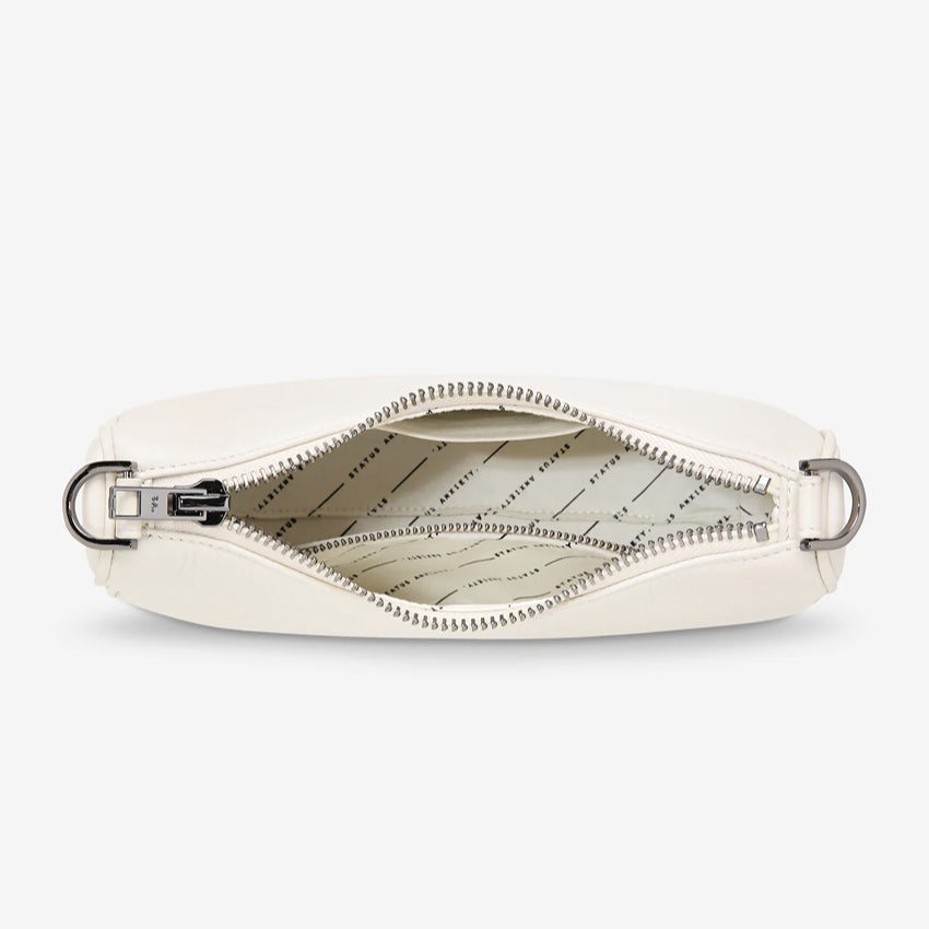 An inside view of the Status Anxiety Look Both Ways Bag in Chalk on a grey background