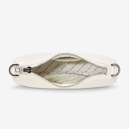 An inside view of the Status Anxiety Look Both Ways Bag in Chalk on a grey background