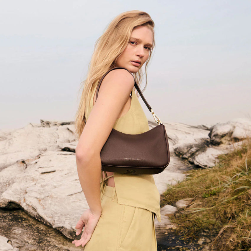 The Status Anxiety Look Both Ways in Cocoa and Brush Gold on a models shoulder 