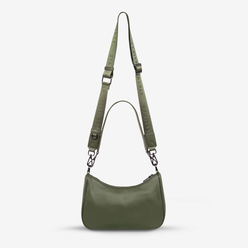 The Status Anxiety Look Both Ways Bag in Khaki on a grey background