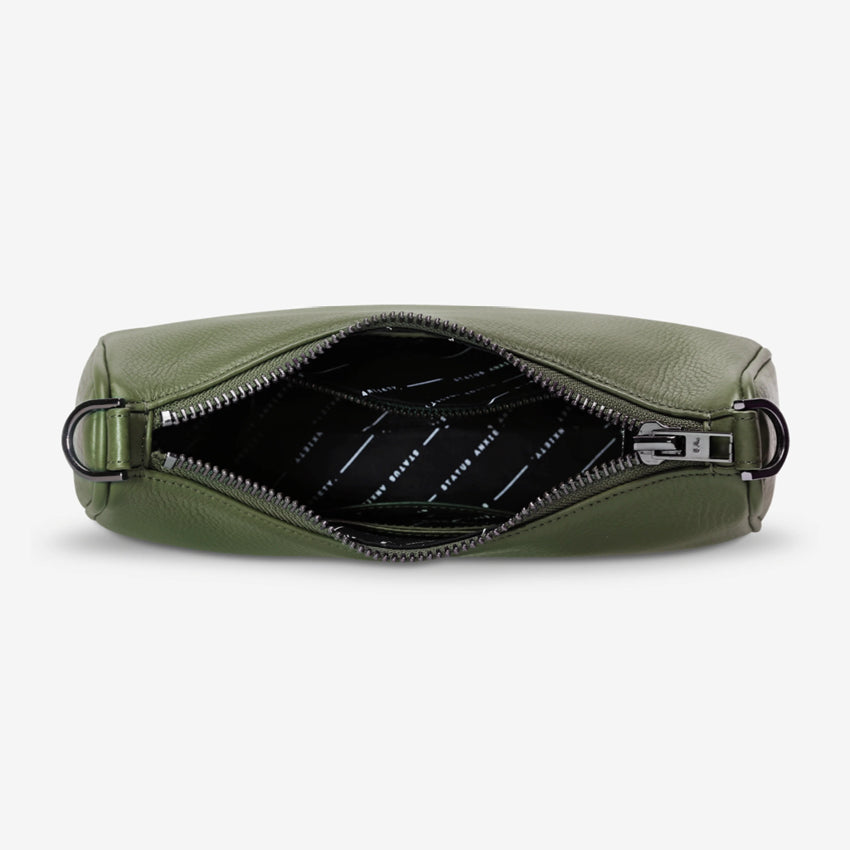 An inside view of the Status Anxiety Look Both Ways Bag in Khaki on a grey background