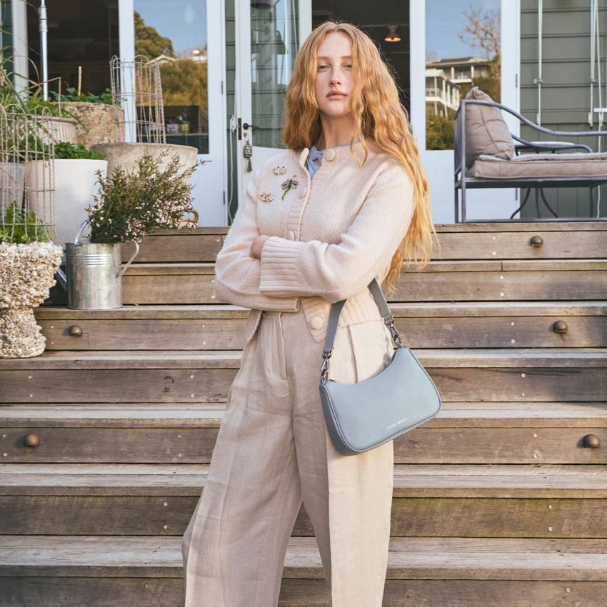A model holding the Status Anxiety Look Both Ways in Powder Blue with the short strap