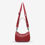 The Status Anxiety Look Both Ways Bag in Rouge on a grey background