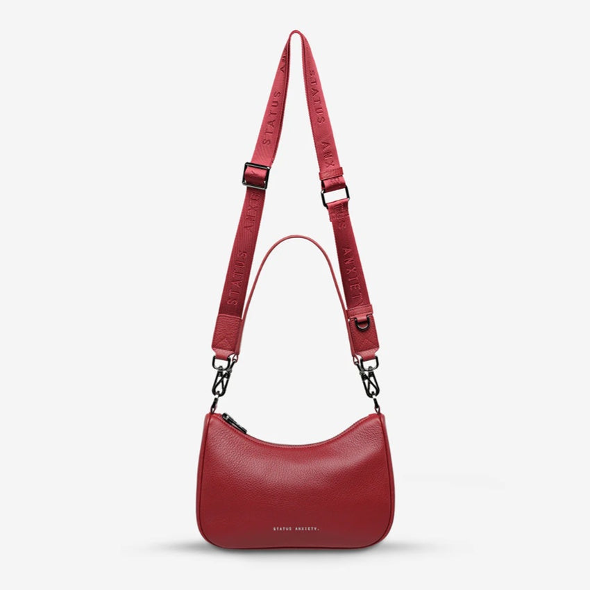 The Status Anxiety Look Both Ways Bag in Rouge on a grey background