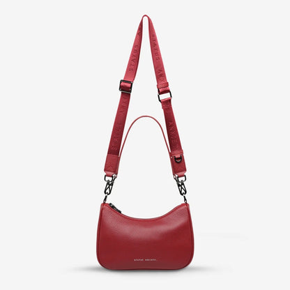 The Status Anxiety Look Both Ways Bag in Rouge on a grey background