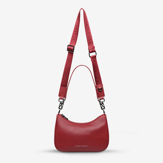 The Status Anxiety Look Both Ways Bag in Rouge on a grey background