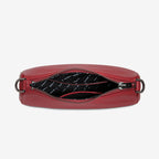 An inside view of the Status Anxiety Look Both Ways Bag in Rouge on a grey background