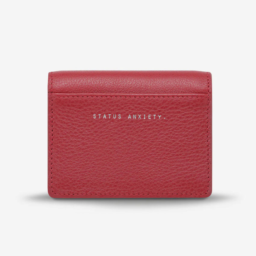 The back of the Status Anxiety Lumen Wallet in Rouge on a blank background