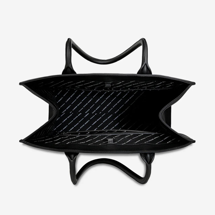 An inside view of the Status Anxiety Without Warning Bag in Black on a grey background