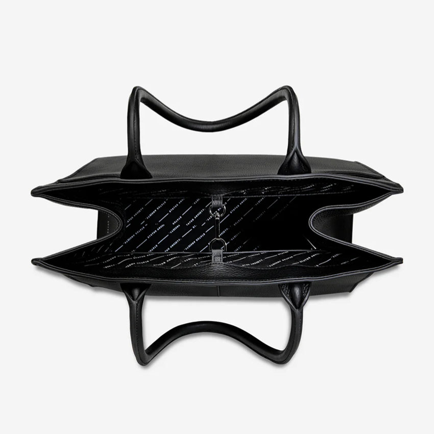 An inside view of the Status Anxiety Without Warning Bag in Black on a grey background
