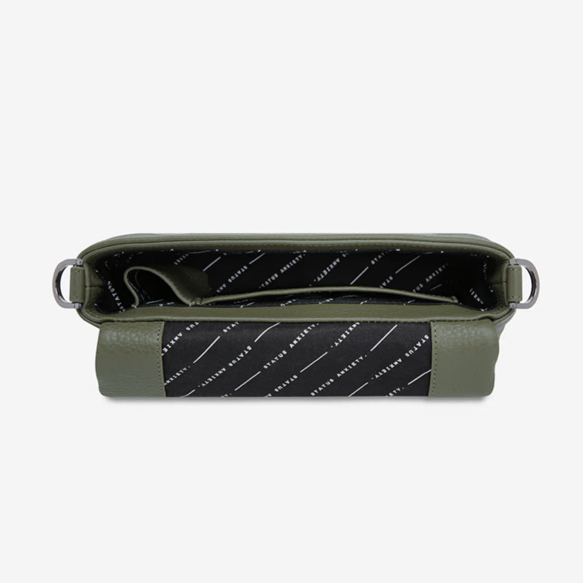 A top view of the Status Anxiety Zenith Bag in Khaki open on a blank background