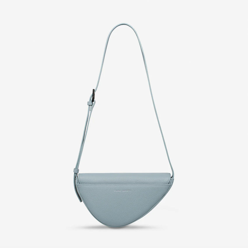 The back of the Status Anxiety Ethereal Handbag in Powder Blue on a blank background