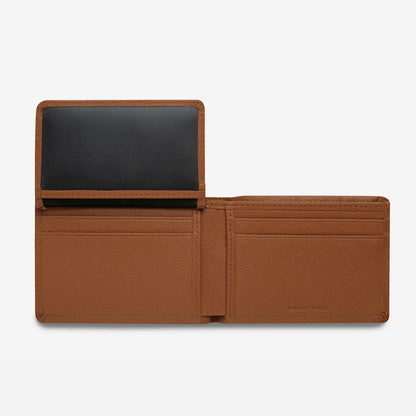 The Status Anxiety Jonah Wallet in Tan open with the flap up on a blank background