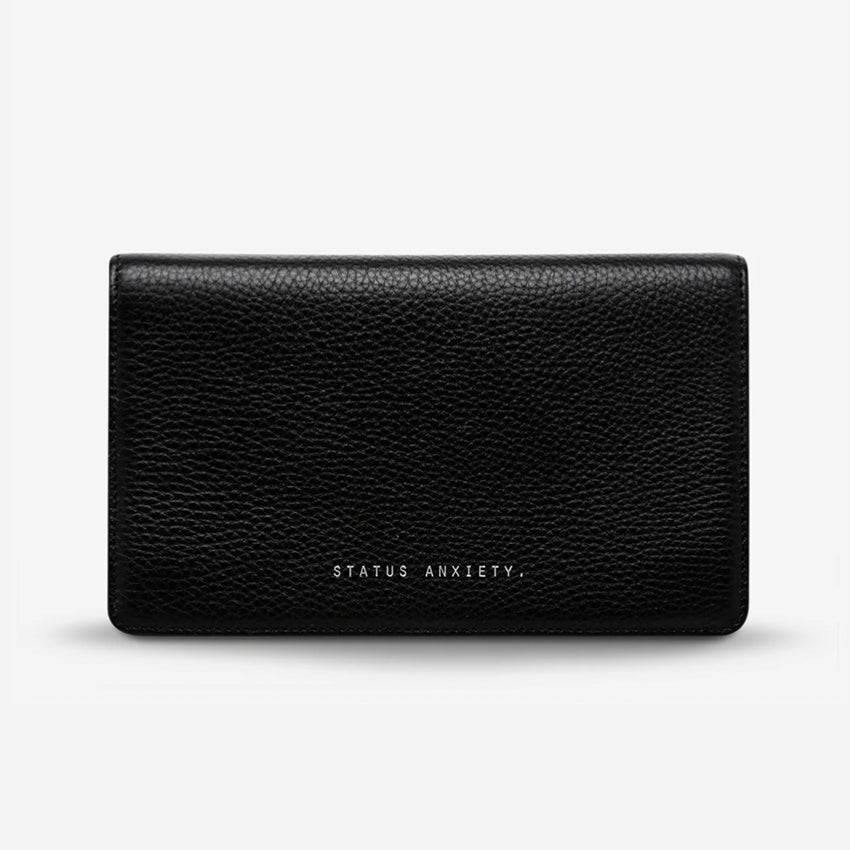 The Status Anxiety Living Proof Wallet in Black on a blank background