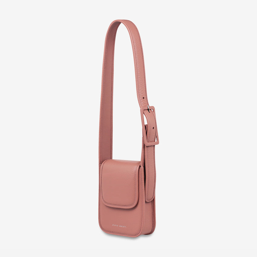 A side view of the Status Anxiety Perplex Bag in Dusty Rose on a blank background