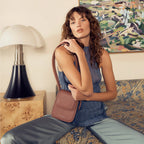 A model with the Status Anxiety Perplex Bag in Dusty Rose on her shoulder