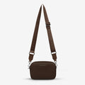 The Status Anxiety Plunder Bag with Webbed Strap in Cocoa on a blank background