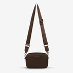 The Status Anxiety Plunder Bag with Webbed Strap in Cocoa on a blank background
