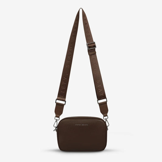 The Status Anxiety Plunder Bag with Webbed Strap in Cocoa on a blank background