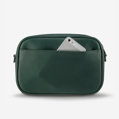 The back of the Status Anxiety Plunder Bag with Webbed Strap in Green with phone in the pocket on a blank background