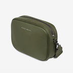 A side view of the Status Anxiety Plunder Bag with a Webbed Strap in Khaki on a blank background
