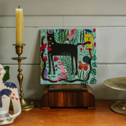 The Studio Soph The Day Dreamer Art Tile on a shelf next to a candle