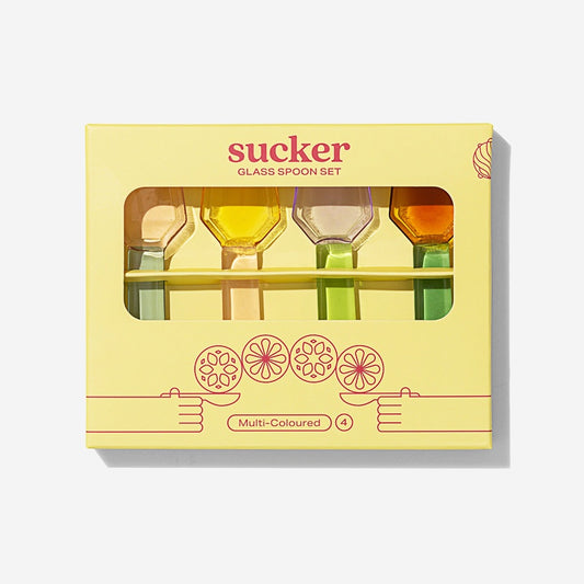 The Sucker Glass Spoon Set in the box packaging on a blank background