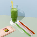The Sucker Reusable Smoothie Straws in Multi, with one in a smoothie and a set packaged 
