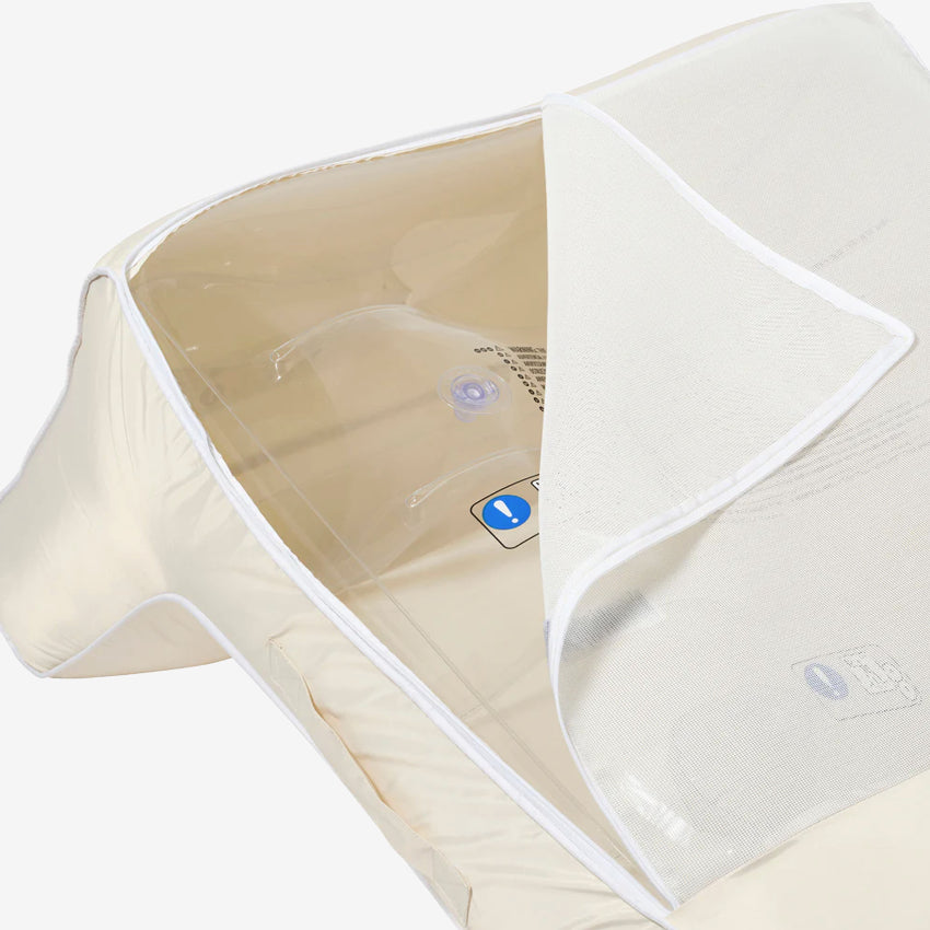 A close up of the Sunny Life Luxe Floating Chair in Cream unzipped on a grey background