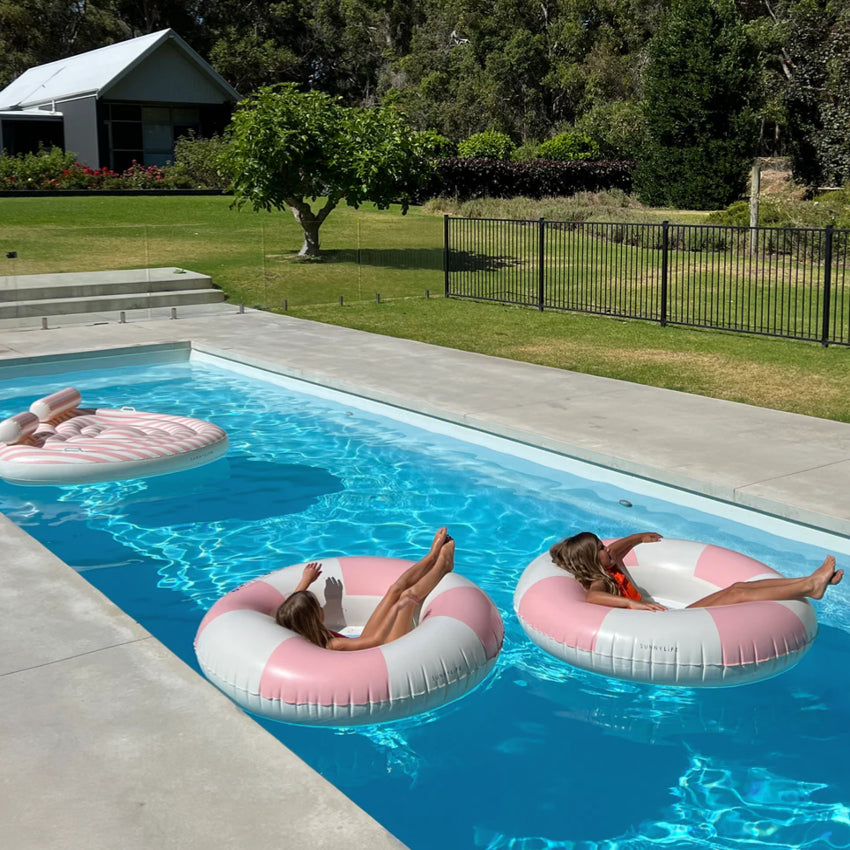 Two of the Sunny Life Luxe Pool Ring in Stole My Heart in a pool with kids in them