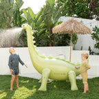 The Sunny Life Dino Giant Sprinkler in a backyard with two kids playing with it
