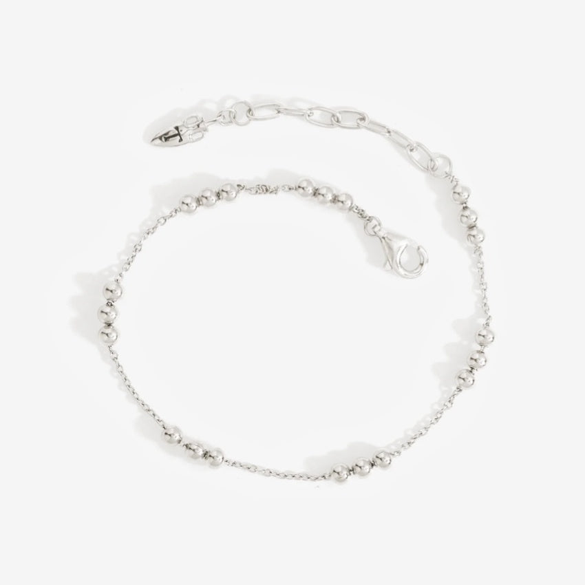 The Temple Of The Sun Alba Station Bracelet in Sterling Silver on a grey background
