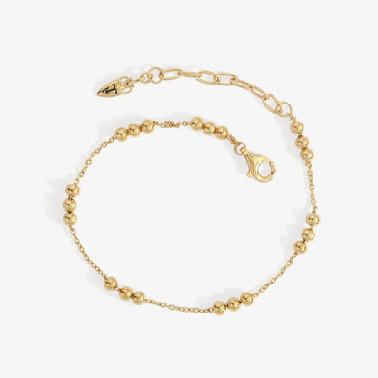 The Temple Of The Sun Alba Station Bracelet in Gold on a grey background