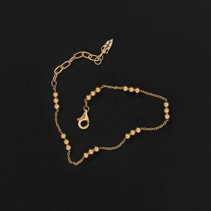 The Temple Of The Sun Alba Station Bracelet in Gold on a black background