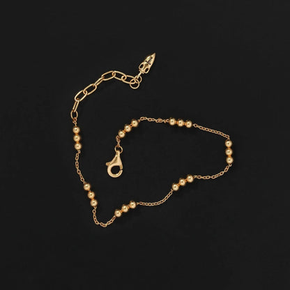 The Temple Of The Sun Alba Station Bracelet in Gold on a black background