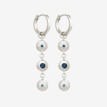 The Temple Of The Sun Blessing Earrings in Sterling Silver on a grey background