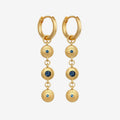 The Temple Of The Sun Blessing Earrings in Gold on a grey background