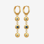 The Temple Of The Sun Blessing Earrings in Gold on a grey background